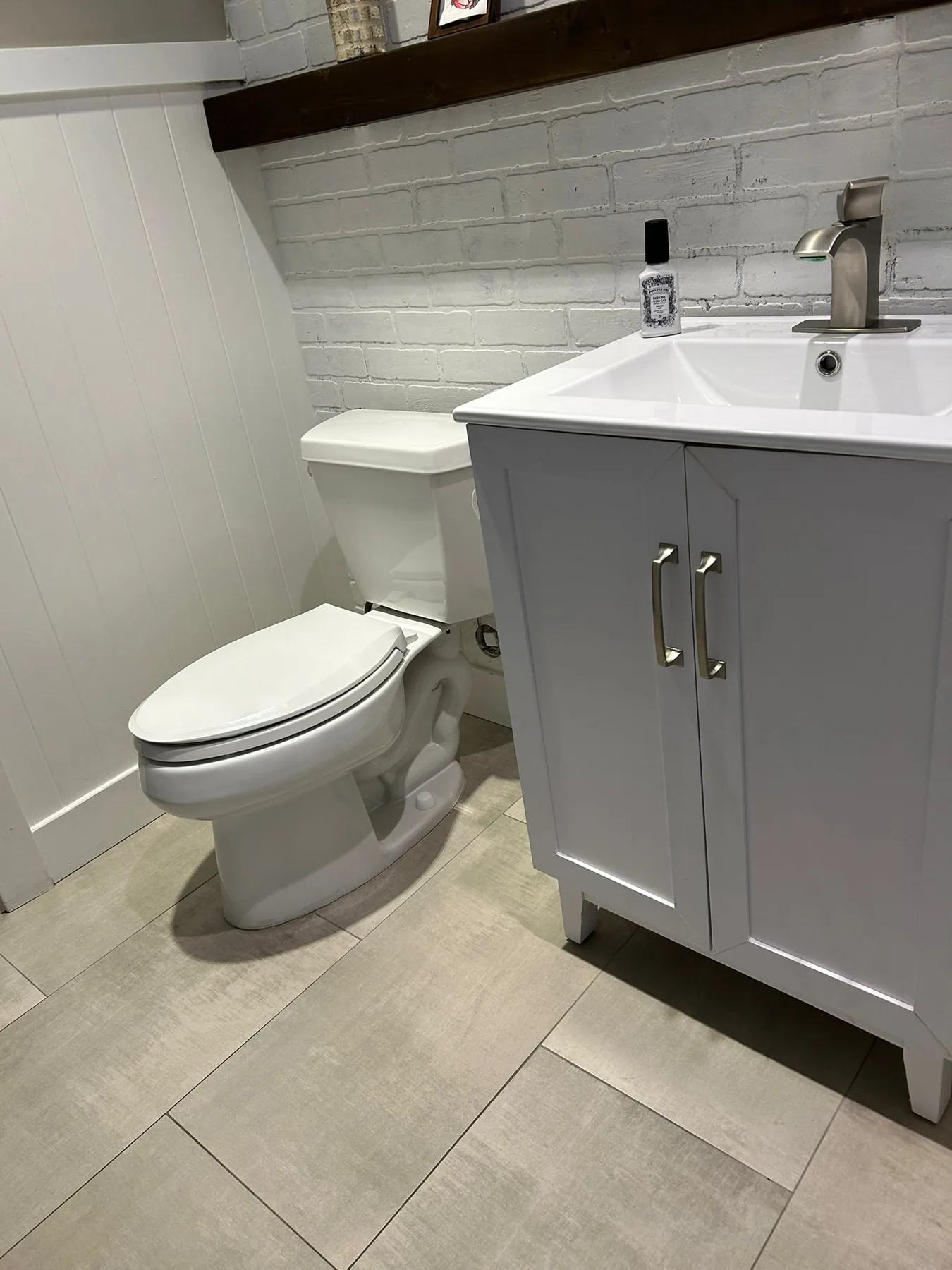 Spotless half bathroom with white vanity and clean tile floor