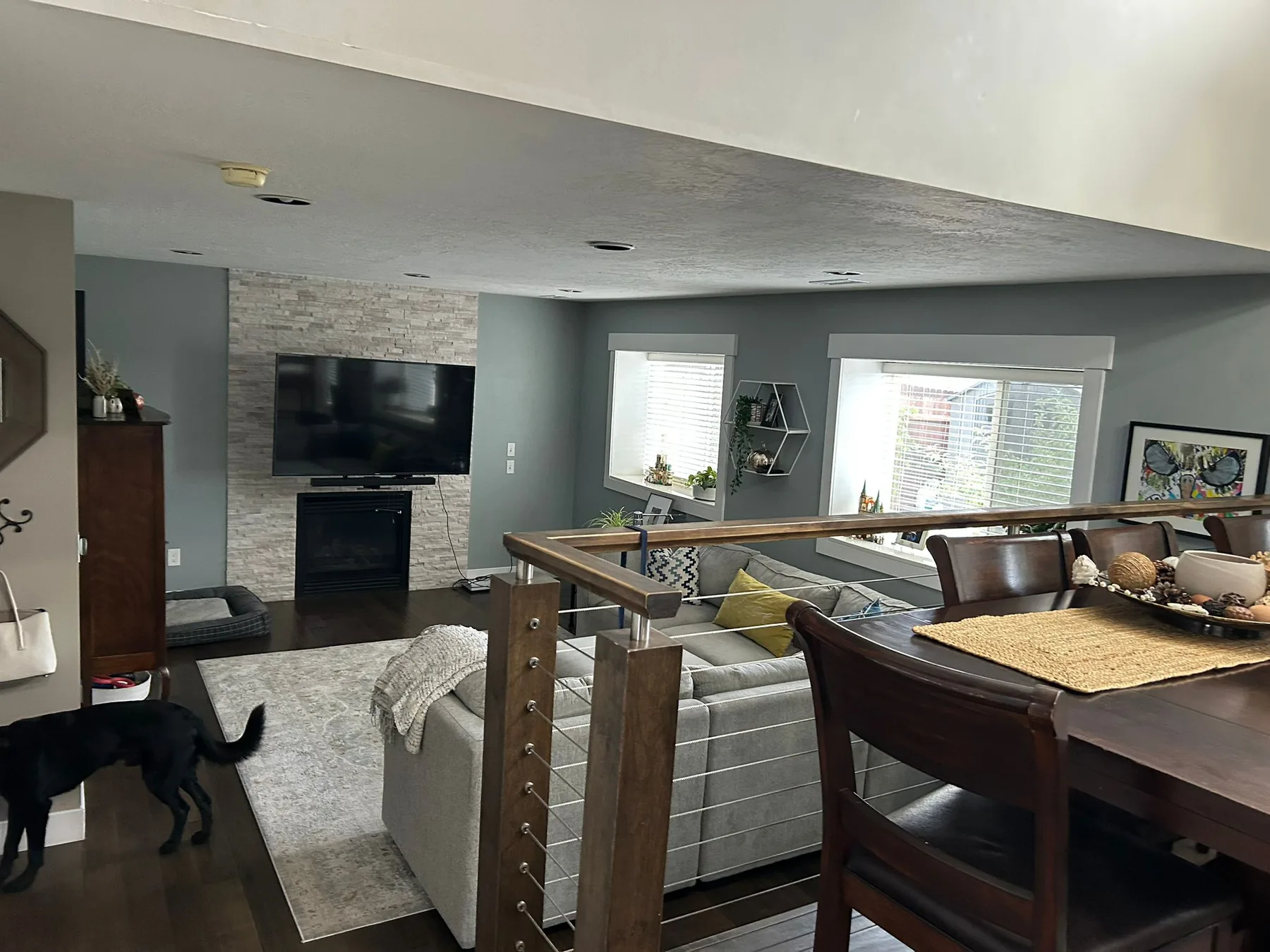 Clean, open living space with sofa, fireplace and dining area