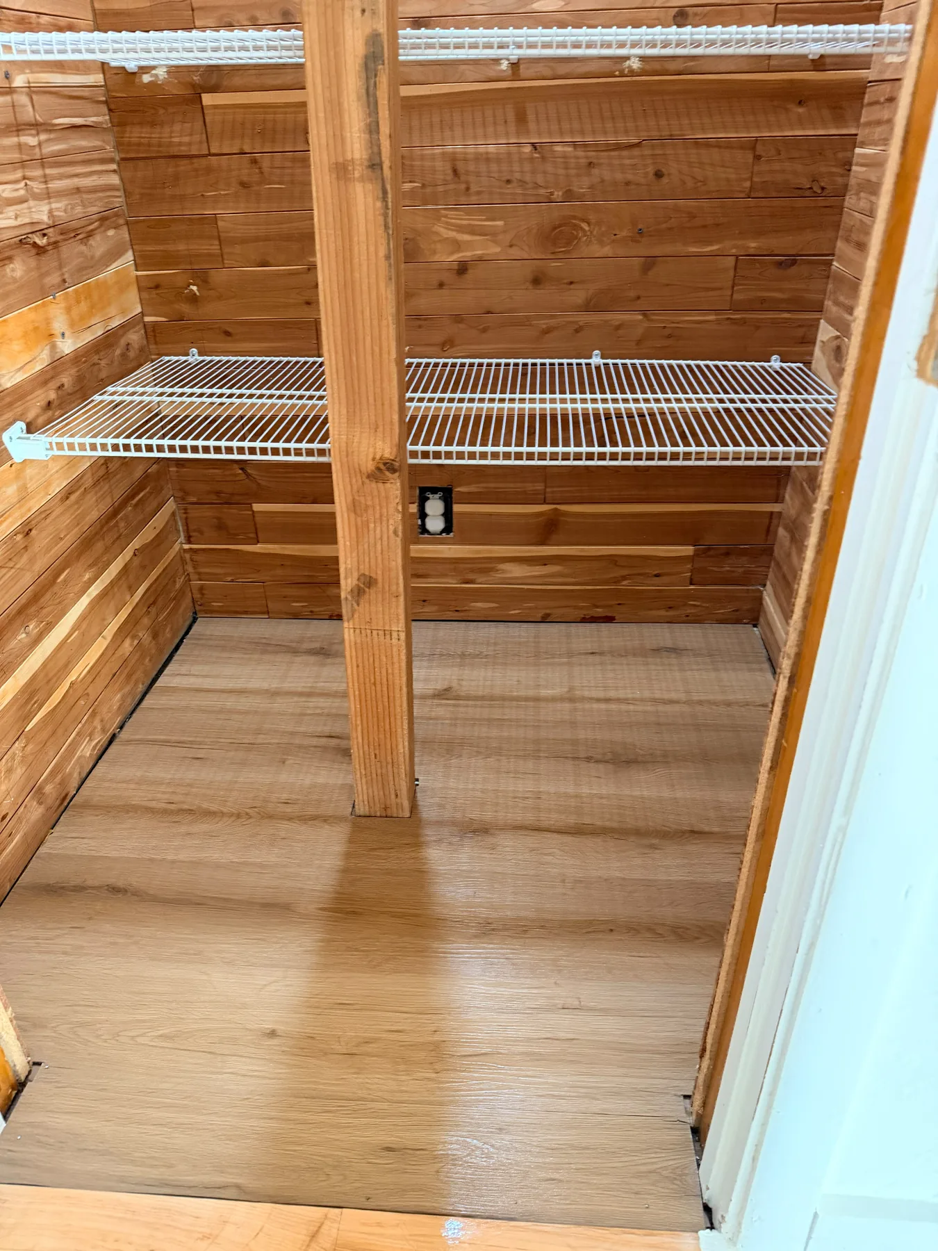 Organized wooden walk-in closet with clean shelves