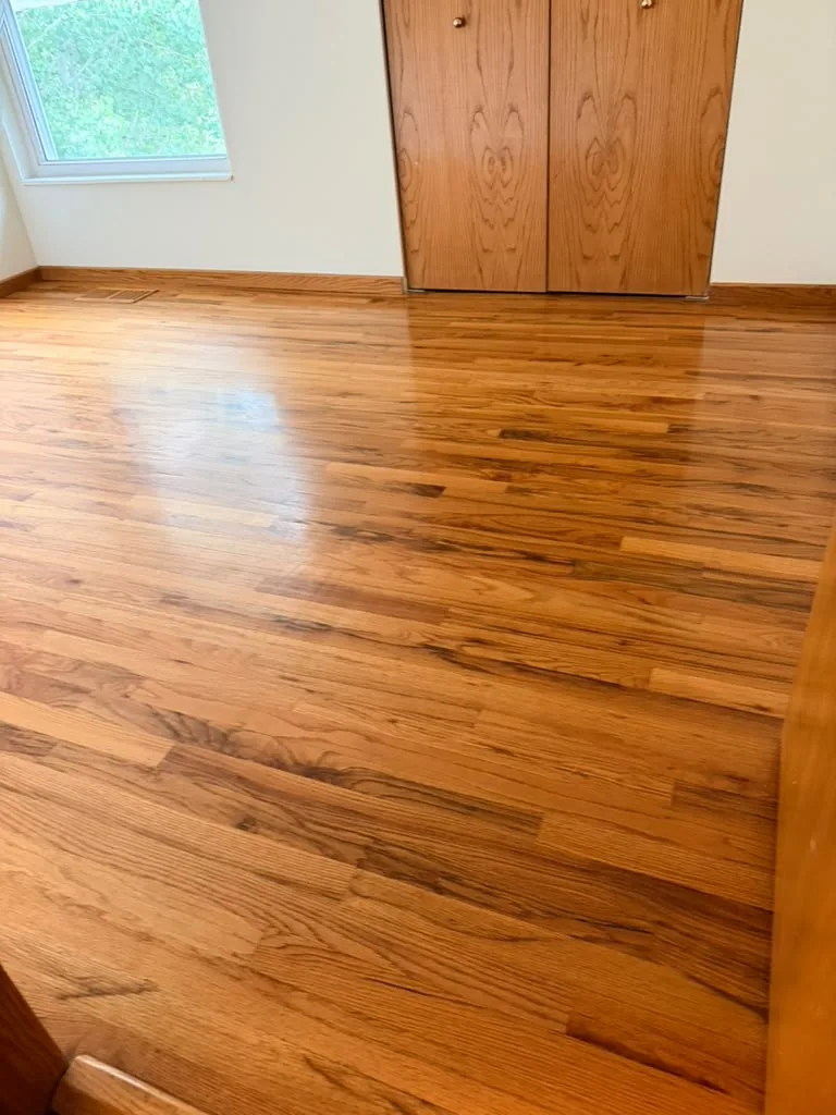 Freshly cleaned, shining hardwood floor in an empty room after a move-out cleaning