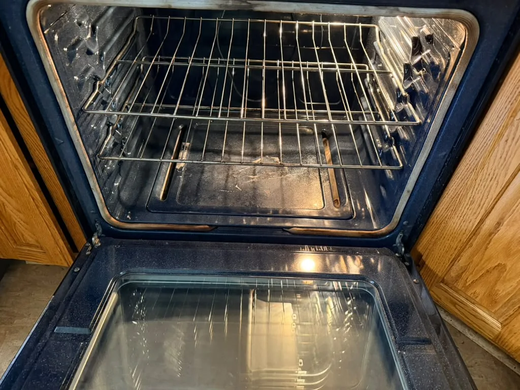 Deep-cleaned oven interior with spotless racks and clear glass door