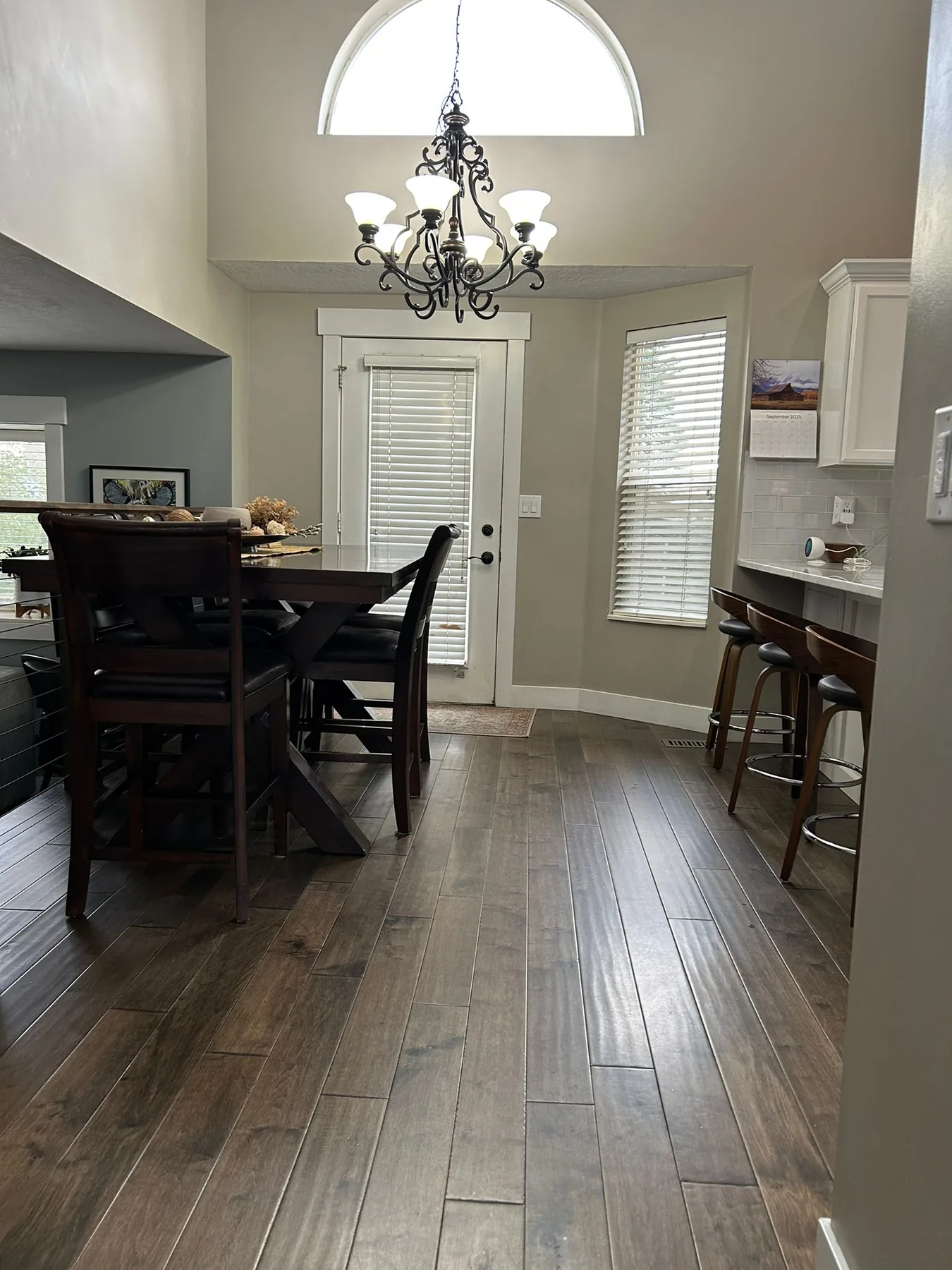 Bright dining area with clean table, chairs and freshly mopped tile floor