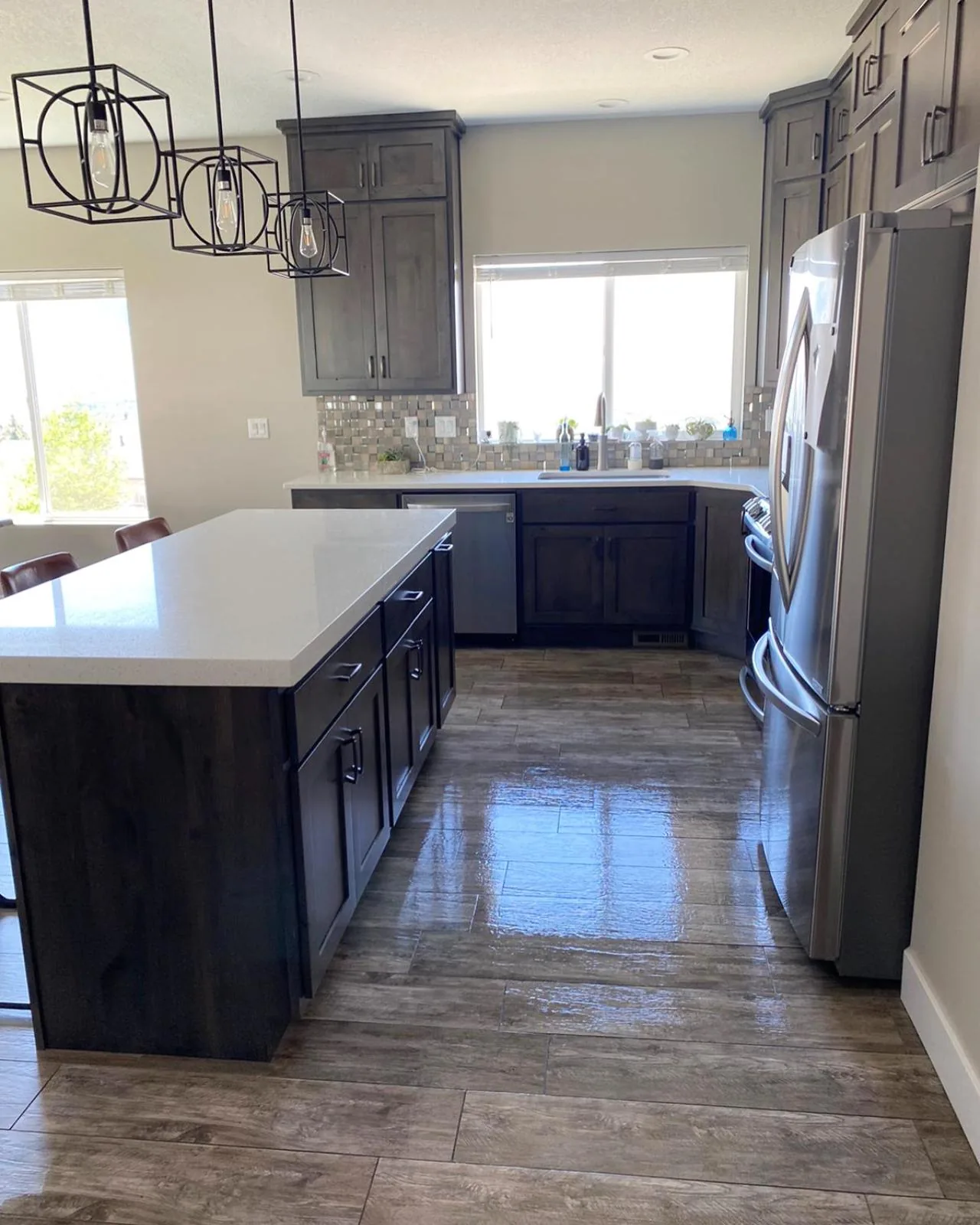 Modern kitchen with freshly mopped, shining tile floors